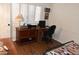 Cozy room featuring a home office setup with a wooden desk and chair near a comfy bed at 13219 W Aleppo Dr, Sun City West, AZ 85375