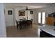 Inviting dining room features stylish decor, tiled flooring, and ample natural light from the french doors at 13219 W Aleppo Dr, Sun City West, AZ 85375