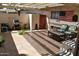 Covered patio is equipped with an outdoor kitchen and comfortable seating at 13219 W Aleppo Dr, Sun City West, AZ 85375