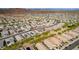 Expansive aerial shot of a well-planned community with uniformly designed homes featuring solar panels at 13529 W Remuda Dr, Peoria, AZ 85383