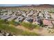 Expansive aerial shot showcases home with solar panels and a pool, nestled in a scenic community at 13529 W Remuda Dr, Peoria, AZ 85383