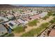 Wide aerial view of a residential neighborhood, featuring a home with a pool and solar panels at 13529 W Remuda Dr, Peoria, AZ 85383