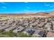 Panoramic aerial view of a neighborhood nestled in a desert landscape with beautiful homes and scenic mountains at 13529 W Remuda Dr, Peoria, AZ 85383