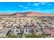 Scenic aerial view of a residential community with mountain views, showcasing well-maintained homes at 13529 W Remuda Dr, Peoria, AZ 85383