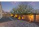 Paver patio in the backyard features a landscape design and privacy wall at 13529 W Remuda Dr, Peoria, AZ 85383