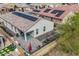 Aerial view of backyard with solar panels, covered patio, outdoor seating, and drought-resistant landscaping at 13529 W Remuda Dr, Peoria, AZ 85383