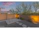 Cozy backyard patio with ambient lighting and low maintenance desert landscaping at 13529 W Remuda Dr, Peoria, AZ 85383