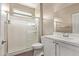 Bathroom features a glass-door shower, toilet and vanity with white cabinets at 13529 W Remuda Dr, Peoria, AZ 85383