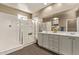 Bathroom featuring a large shower with a glass door, double sinks, and tile flooring at 13529 W Remuda Dr, Peoria, AZ 85383