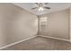 Neutral carpeted bedroom with ceiling fan and window letting in lots of light at 13529 W Remuda Dr, Peoria, AZ 85383