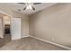 Bedroom with carpet flooring has a ceiling fan and an entrance to the laundry room at 13529 W Remuda Dr, Peoria, AZ 85383