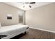 Minimalist bedroom with wood floors, a ceiling fan, and a window offering natural light at 13529 W Remuda Dr, Peoria, AZ 85383