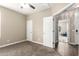 Bedroom featuring neutral carpet, ceiling fan, and attached open room and doors to other spaces at 13529 W Remuda Dr, Peoria, AZ 85383