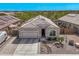 Charming single-Gathering home featuring desert landscaping, a two-car garage, and solar panels for energy efficiency at 13529 W Remuda Dr, Peoria, AZ 85383