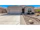 Beautiful front exterior with desert landscaping, paved walkway, and a spacious driveway leading to the garage at 13529 W Remuda Dr, Peoria, AZ 85383