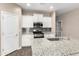 Bright kitchen featuring white cabinets, stainless steel appliances, and a granite countertop island at 13529 W Remuda Dr, Peoria, AZ 85383