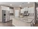 Modern kitchen featuring granite countertops, stainless steel appliances, white cabinets, and a center island at 13529 W Remuda Dr, Peoria, AZ 85383