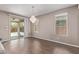 Living area with a sliding glass door to the patio, tile floors, and a hanging chandelier at 13529 W Remuda Dr, Peoria, AZ 85383