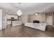 Bright and airy living room featuring a large chandelier, tile floors, contemporary furniture, and an open layout at 13529 W Remuda Dr, Peoria, AZ 85383