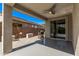 Covered patio with ceiling fan and sliding glass doors to seamlessly integrate indoor and outdoor living at 13529 W Remuda Dr, Peoria, AZ 85383