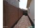 Rock ground side yard featuring a fence and access to the back of the house at 14132 W Valentine St, Surprise, AZ 85379