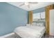 Bright bedroom with a full-sized bed, neutral bedding, ceiling fan, and blue accent wall at 1435 W 6Th St, Mesa, AZ 85201