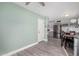 Bright dining area with green walls, gray flooring, and stainless steel refrigerator at 1435 W 6Th St, Mesa, AZ 85201