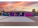 Charming single-story home featuring unique gravel landscaping and colorful pink garage door at 1435 W 6Th St, Mesa, AZ 85201