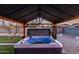 Inviting hot tub nestled under a wooden pergola, creating a private outdoor oasis at 1435 W 6Th St, Mesa, AZ 85201