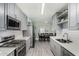 Well-lit kitchen featuring gray cabinetry, stainless steel appliances, and an eat-in dining area at 1435 W 6Th St, Mesa, AZ 85201