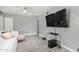 Open living room featuring light gray walls, a ceiling fan, and neutral-toned furniture at 1435 W 6Th St, Mesa, AZ 85201