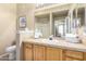 Bright bathroom featuring a vanity with ample storage, a large mirror, and a shower at 14950 W Mountain View Blvd # 5207, Surprise, AZ 85374