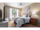 Serene bedroom with a ceiling fan, a large window, and a calm, neutral color palette at 14950 W Mountain View Blvd # 5207, Surprise, AZ 85374