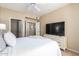 Inviting bedroom featuring a walk-in closet, a large television, and a bright, airy feel at 14950 W Mountain View Blvd # 5207, Surprise, AZ 85374