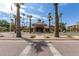 Elegant community clubhouse featuring manicured landscaping, palm trees, and a welcoming entrance at 14950 W Mountain View Blvd # 5207, Surprise, AZ 85374