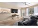 Comfortable living room featuring contemporary furnishings, a ceiling fan, and a view into the kitchen at 14950 W Mountain View Blvd # 5207, Surprise, AZ 85374