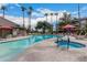 Beautiful pool with a spa and lounge chairs amidst a tropical landscape and clear blue skies at 14950 W Mountain View Blvd # 5207, Surprise, AZ 85374