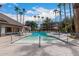 Inviting community pool with lounge chairs, palm trees, and clear blue water for recreation at 14950 W Mountain View Blvd # 5207, Surprise, AZ 85374