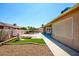 Backyard with a water fountain and a small grassy patch near the property fence at 1538 E Peach Tree Dr, Chandler, AZ 85249