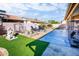 Beautiful backyard featuring artificial turf, a fountain, and lounge chairs at 1538 E Peach Tree Dr, Chandler, AZ 85249