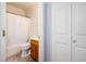 Bathroom with a white shower curtain, wood vanity, and neutral-colored tile floors at 1538 E Peach Tree Dr, Chandler, AZ 85249