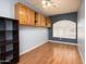 Bonus room with wood laminate flooring, overhead storage and a white shuttered window at 1538 E Peach Tree Dr, Chandler, AZ 85249
