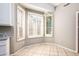 Bright breakfast nook with decorative lighting fixture and white shuttered windows at 1538 E Peach Tree Dr, Chandler, AZ 85249