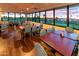 Bright dining area with floor-to-ceiling windows offering views of golf course, creating an inviting space for meals at 1538 E Peach Tree Dr, Chandler, AZ 85249