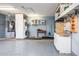Garage with laundry area, storage cabinets, and an epoxy floor at 1538 E Peach Tree Dr, Chandler, AZ 85249