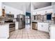 Bright, updated kitchen with stainless steel appliances and white cabinetry at 1538 E Peach Tree Dr, Chandler, AZ 85249