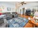 Spacious living room with wood floors, a ceiling fan, and comfortable seating at 1538 E Peach Tree Dr, Chandler, AZ 85249