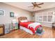 Inviting main bedroom with a ceiling fan, shuttered windows, and warm wood flooring at 1538 E Peach Tree Dr, Chandler, AZ 85249