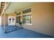 Covered patio area with a ceiling fan, double glass doors, and textured stucco walls at 1538 E Peach Tree Dr, Chandler, AZ 85249
