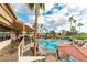 Stunning outdoor pool area featuring multiple pools and resort-style amenities surrounded by lush landscaping and blue skies at 1538 E Peach Tree Dr, Chandler, AZ 85249